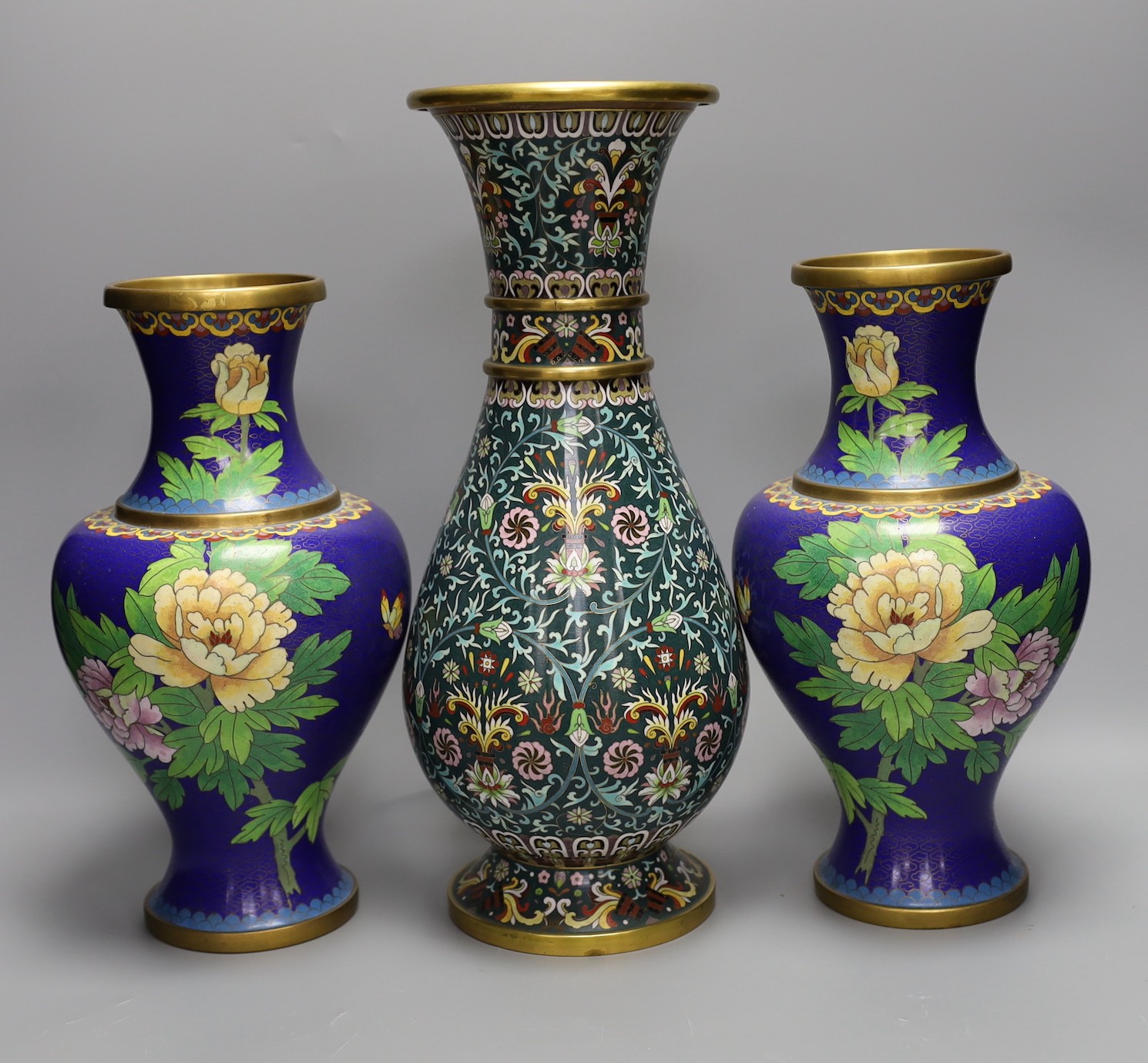 Seven Chinese cloisonné enamel vases and a bowl, tallest 39 cms high